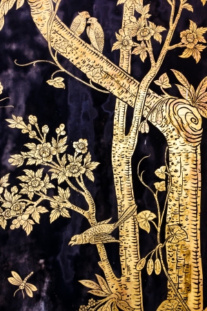 The old image of trees and birds and dragonfly on wall in thai templeの写真素材