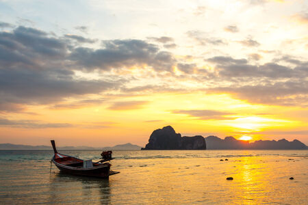 native boat on beach and sunrise in morning at Trang ,Thailandの写真素材