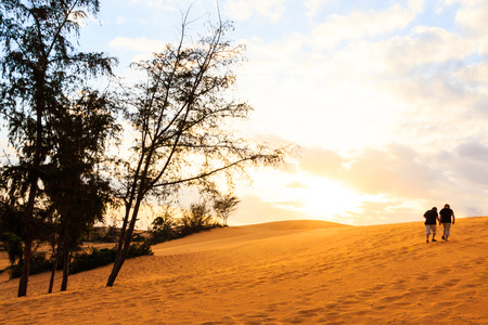 twin asian human are walking on Mui Ne sand dune when sunset ,South Vietnamの写真素材