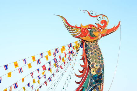 Tip of boat was decorated to swan shape and Flags in evening at Golden Triangle ,Chiangrai ,Thailandの写真素材
