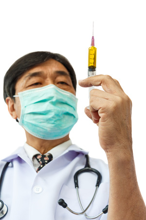 asian doctor is holding syringe on white backgroundの写真素材