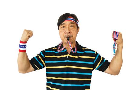 Thai man hold whistle ,blow a whistle and wear wristband on white backgroundの写真素材