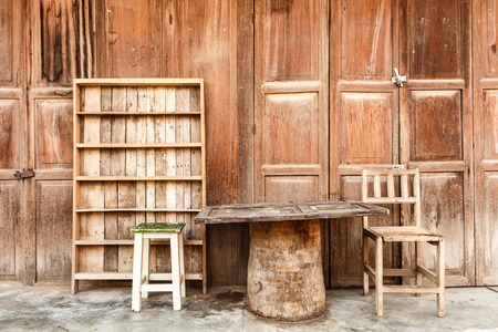 Wooden table,chairs,shelf in front of wooden house  rural scene  at Chiang Khan ,Thailandの写真素材
