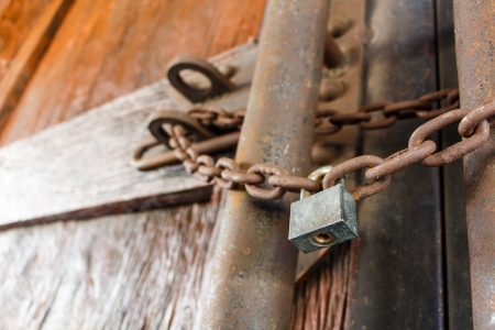 rusty chain and master key lock wood doorの写真素材