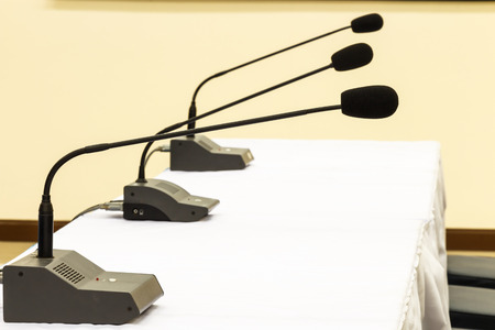 Microphones on table in a conference roomの写真素材