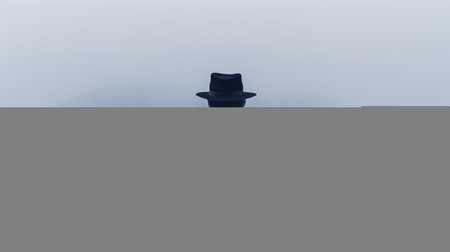 a man wearing a cloak and hat stands by the water's edge, his silhouette blending into the smokey background. the uncanny and eerie atmosphere is enhanced by the wandering eye. this high-resolution photo by john wilhelm captures a sombre and anglocore aesthetic. ai generatedの素材