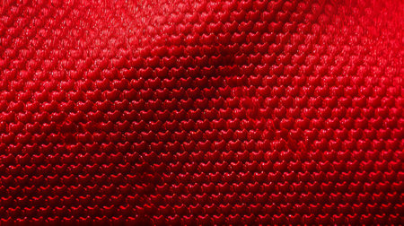 a red cloth texture stock photo showcasing cellular formations and metallic surfaces. this unconventional material features a woven-perforated pattern in shades of red and emerald. the image has a resolution of 3840x2160, providing a detailed and rounded visual experience. ai generatedの素材
