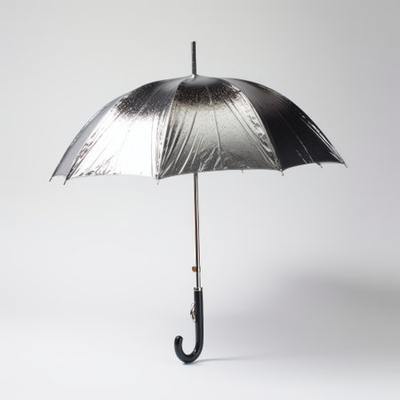 metal and black umbrella held in the middle of a white background, resembling liquid metal. this unique umbrella features a dark indigo and silver color scheme, reminiscent of the years 1860-1969. captured using infrared film, the image exudes a bubble goth aesthetic, combining stark honesty with a bright luster. ai generatedの素材