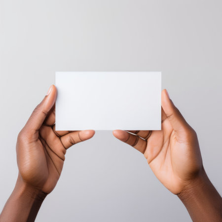 women's hands hold up blank business cards on a grey background, showcasing an afro-caribbean influence. captured with a ricoh gr iii, this visually compelling image tells a narrative-driven story. the white background and large-scale canvas create a powerful impact, while the relatable personality and light white tones add depth to the composition. ai generatedの素材