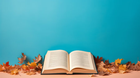 open book with autumn leaves on a blue background, featuring bold chromaticity, light beige, and turquoise. the image showcases witty and satirical commentary, with a found-object-centric approach. the uniformly staged composition highlights bright, bold colors, reminiscent of classical academic aesthetics. ai generatedの素材