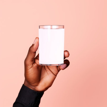 hand holding glass of milk against pink background in harlem renaissance style. minimal retouching, genderless representation, use of precious materials, installation-based concept. streamlined design with white background. ai generatedの素材