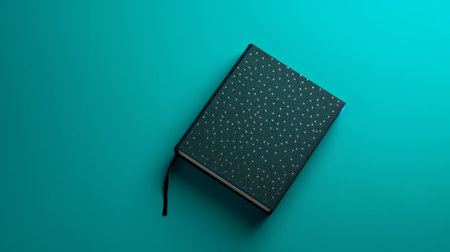 an open book with black dots on a green background, featuring a dark sky-blue and aquamarine color scheme. the composition is simple yet elegant, with texture-rich surfaces. the high-angle shot creates a contrasting effect. this photo, inspired by escher, can be found on flickr. ai generatedの素材