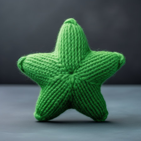 a green knitted star stuffed animal with white stripes is showcased in this tabletop photograph. the soft and rounded forms of the toy, along with its brightly colored design, exude a nautical charm. the black background adds depth and enhances the visual appeal of the image. this captivating photograph was captured by mandy disher, an associated press photographer. ai generatedの素材