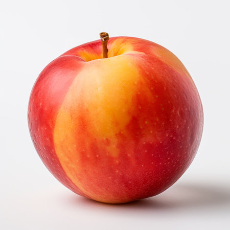 a vibrant red apple with a light pink and yellow color scheme, showcasing smooth and curved lines. the explosive pigmentation creates a striking visual impact, while incorporating elements of smilecore. the apple features shades of dark orange and light gold, with subtle shading techniques reminiscent of the vancouver school. ai generatedの素材