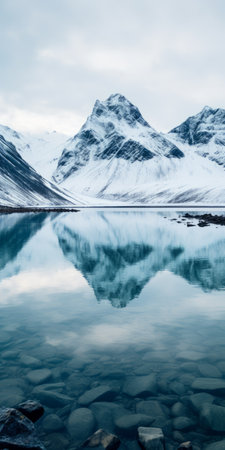 a stunning photo of a fjord in iceland, showcasing the breathtaking beauty of nordfjord road leading to the majestic masherbrum mountain. the snowy peaks of dhaulagiri add to the picturesque landscape. the image captures the essence of nature's grandeur, with a touch of animated gif-style af sweaters and minimalist typography. the fantastic mr. fox-esque vibe is enhanced by the symmetrical arrangement and the presence ofの素材