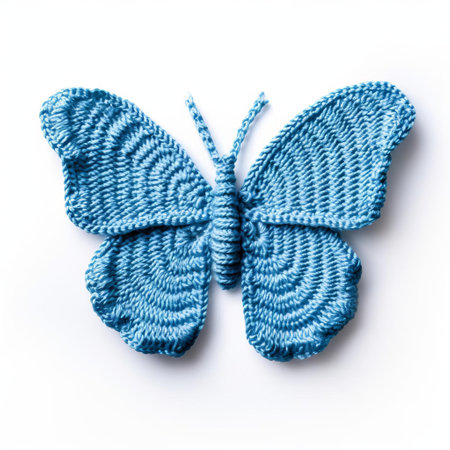 the delicate knitted butterfly, with intricate thread details and vibrant colors, sits serenely isolated on a pristine white background, showcasing the beauty of handmade textile art, perfect for craft inspiration, diy projects, and nature enthusiasts. ai generatedの素材