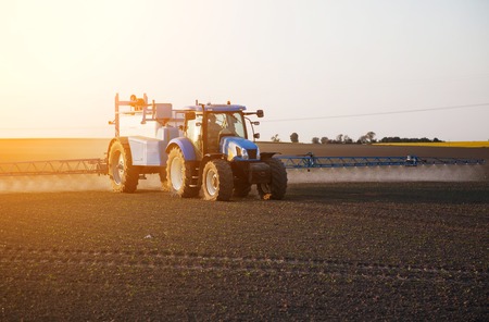 Farmer spraying field with chemicals.の写真素材