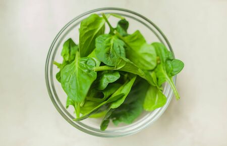 Overhead view of healthy spinach in bowl on tableの写真素材