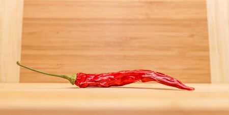 Closeup of red chili on wooden table
