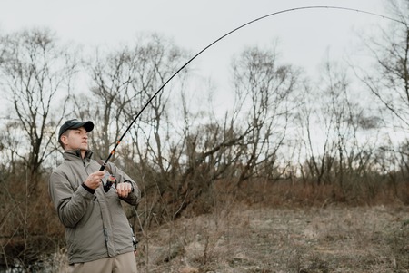 Young man is fishingの写真素材