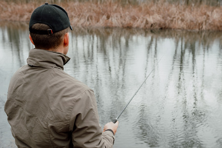 Young man is fishingの写真素材
