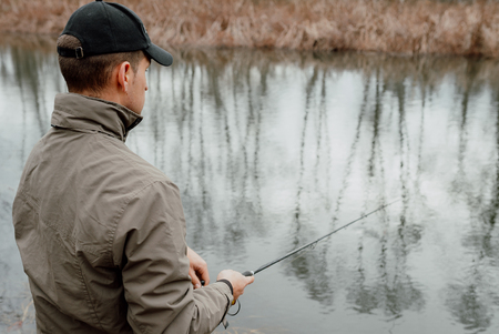 Young man is fishingの写真素材