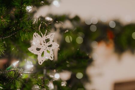 Beautiful handmade crochet snowflake. Minimalistic Christmas decor. Beautiful white tree decorations which are simple and ecological. Fluffy snowflake from white yarnの写真素材