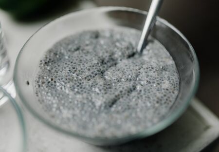 Close Up of Chia Pudding in Glass Bowl in Kitchenの写真素材