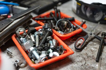 close up of different types of screws in a plastic box