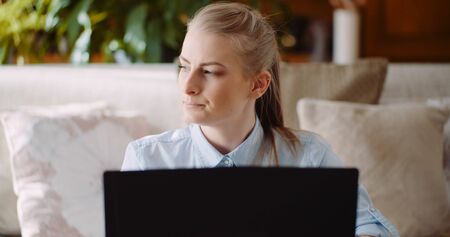 Confident Woman working on laptop at homeの写真素材