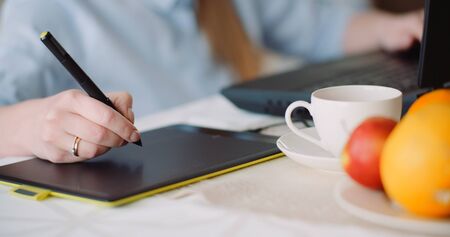 Architect Drawing on Touchpad and using Laptopの写真素材