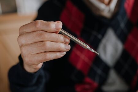 Old Man Holding Thermometer in hand Covid-19の写真素材