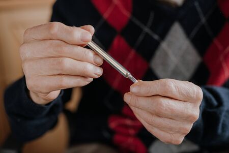 Old Man Holding Thermometer in hand Covid-19の写真素材