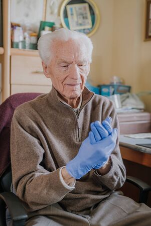 Portrait of Old man wearing Protective Gloves against Covid-19の写真素材