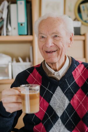 Portrait of happy senior drinking coffeeの写真素材