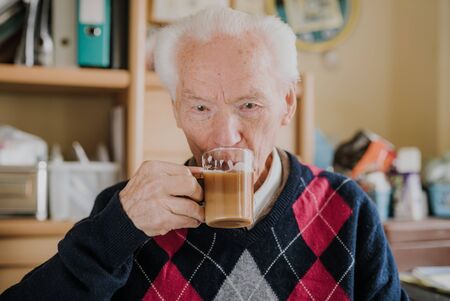 Portrait of happy senior drinking coffeeの写真素材