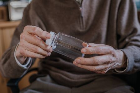 Senior holding an empty medicine bottle