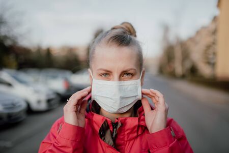 Portrait of Woman Wearing Protective Mask Against Covid-19 Outdoorsの写真素材