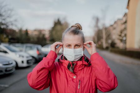 Portrait of Woman Wearing Protective Mask Against Covid-19 Outdoorsの写真素材