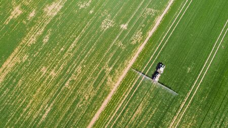 Agriculture Tractor Working in Fieldの写真素材
