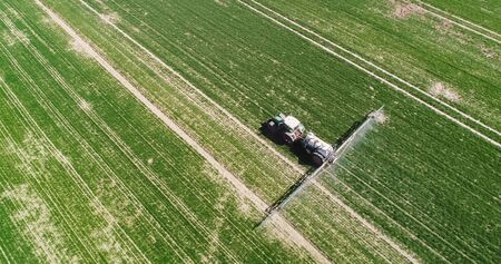 Agriculture Tractor Working in Fieldの写真素材