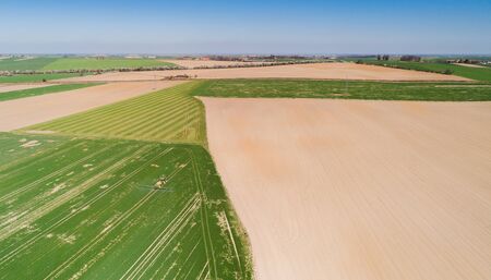Agriculture Tractor Working in Fieldの写真素材