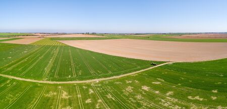 Agriculture Tractor Working in Fieldの写真素材
