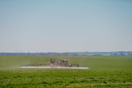 Tractor Spraying Herbicides on Field Agricultureの写真素材