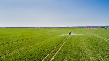 Tractor Spraying Herbicides on Field Agricultureの写真素材