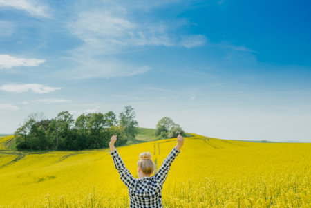 Farmer in rape fieldの写真素材