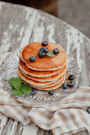 Fresh Pancakes on Plate. Close up of Delicious Dessert. Pancakes and Bluberry on top.の写真素材