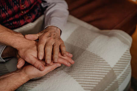 Comforting Elderly Senior Man Hands Close Up. Giving Care.の写真素材