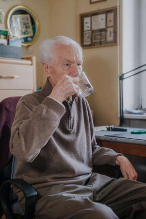 Old man drinking water closeupの写真素材