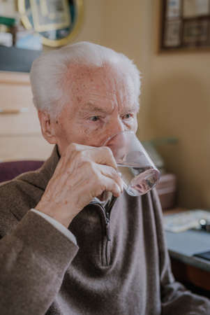 Old man drinking water closeupの写真素材